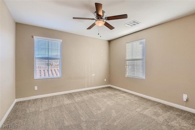 carpeted spare room with ceiling fan