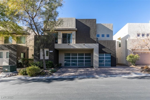 modern home with a balcony and a garage