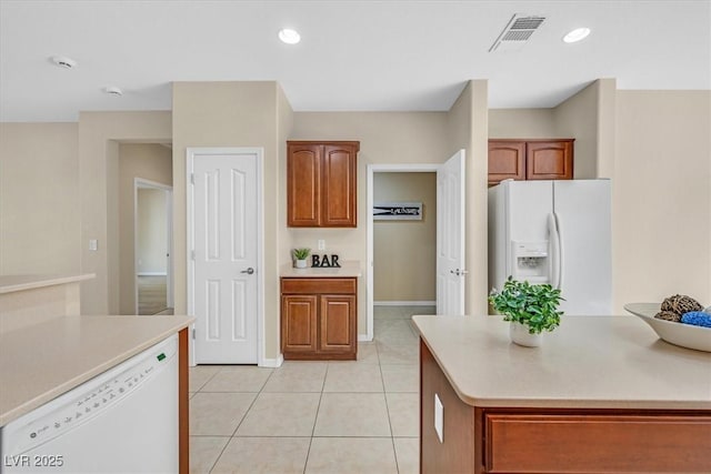 kitchen with light tile patterned floors and white appliances