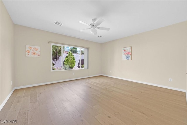 empty room featuring light wood-type flooring and ceiling fan