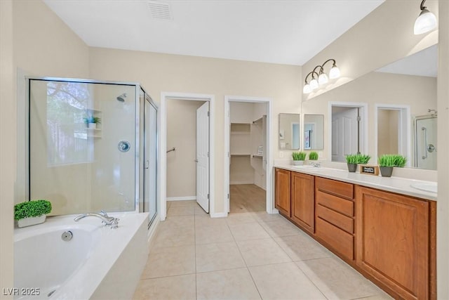 bathroom featuring tile patterned floors, vanity, and independent shower and bath