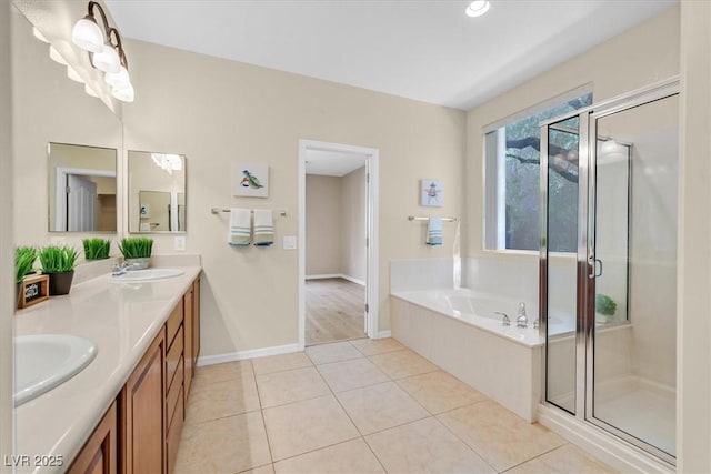 bathroom featuring tile patterned floors, vanity, and shower with separate bathtub