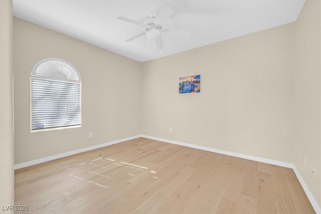 spare room featuring light wood-type flooring and ceiling fan