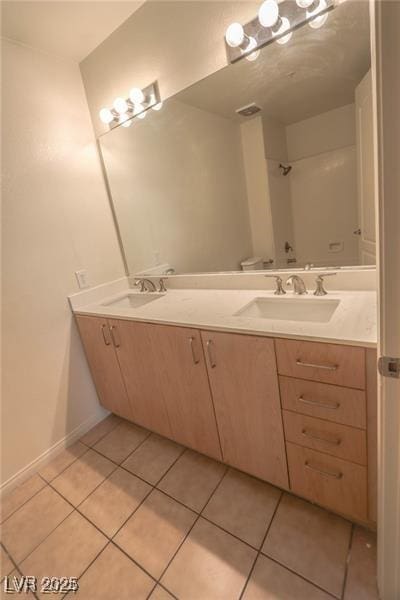 bathroom with tile patterned flooring and vanity