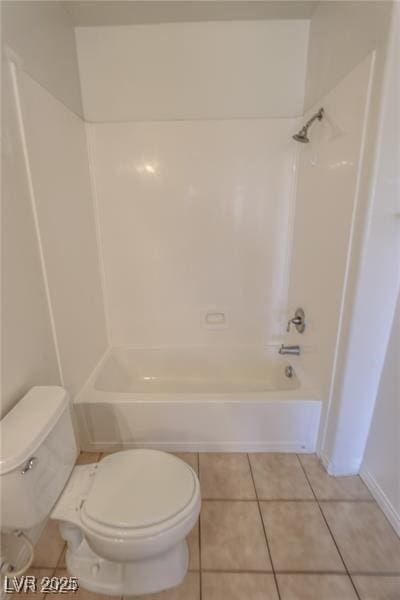 bathroom featuring tile patterned floors, toilet, and bathtub / shower combination