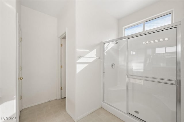 bathroom featuring a shower with shower door