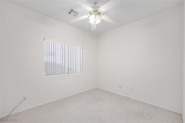 unfurnished room featuring ceiling fan and light carpet