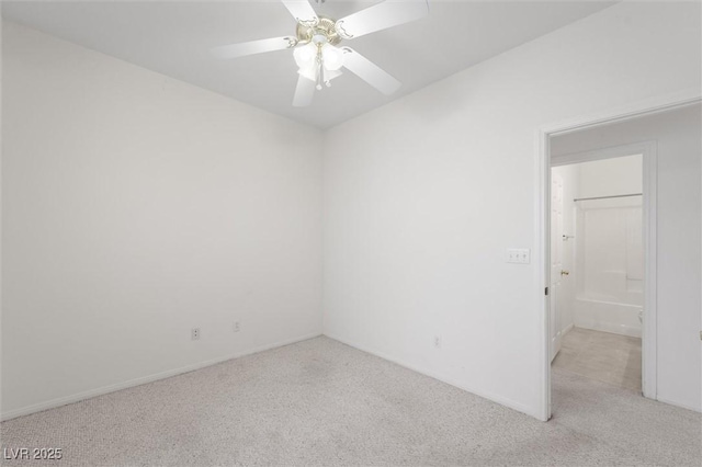 empty room featuring ceiling fan and light colored carpet