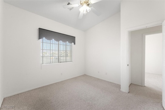 spare room with ceiling fan, light colored carpet, and lofted ceiling