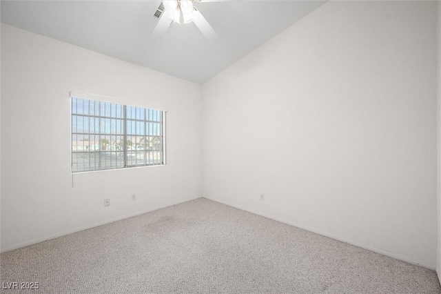 empty room featuring ceiling fan, carpet floors, and vaulted ceiling