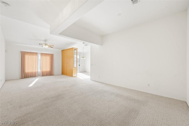 carpeted spare room featuring ceiling fan