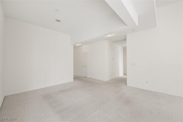 spare room featuring light colored carpet