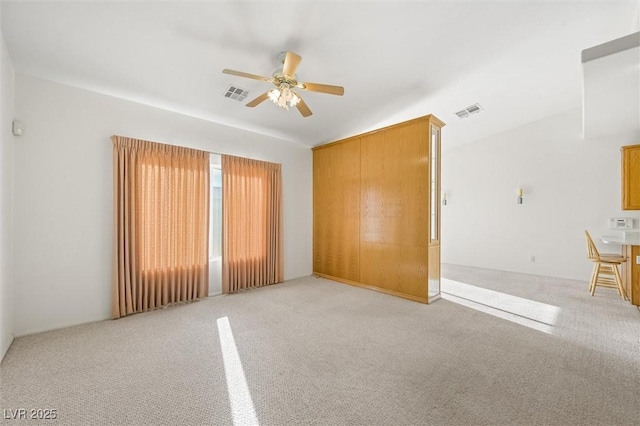 unfurnished room with ceiling fan and light colored carpet