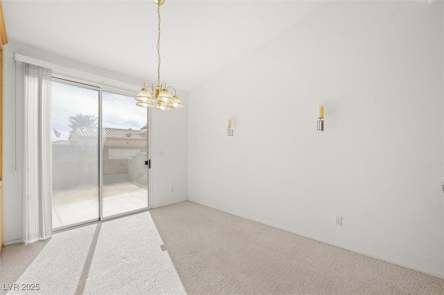 empty room featuring light carpet and an inviting chandelier