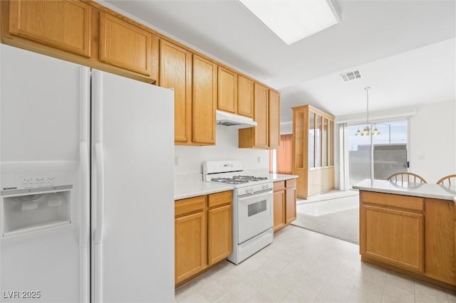 kitchen with decorative light fixtures, white appliances, and a notable chandelier