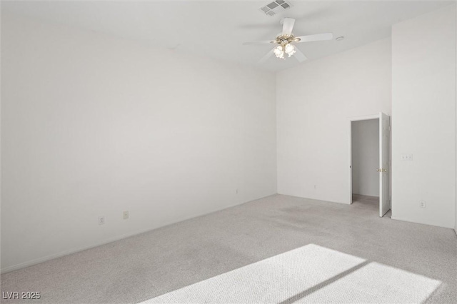 carpeted empty room featuring ceiling fan