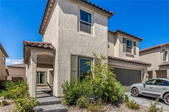 mediterranean / spanish-style home with a garage