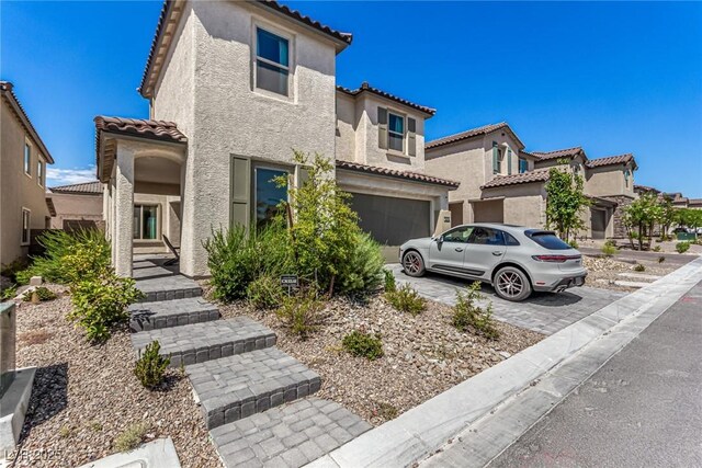 mediterranean / spanish home featuring a garage