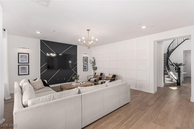 living room with hardwood / wood-style floors and an inviting chandelier