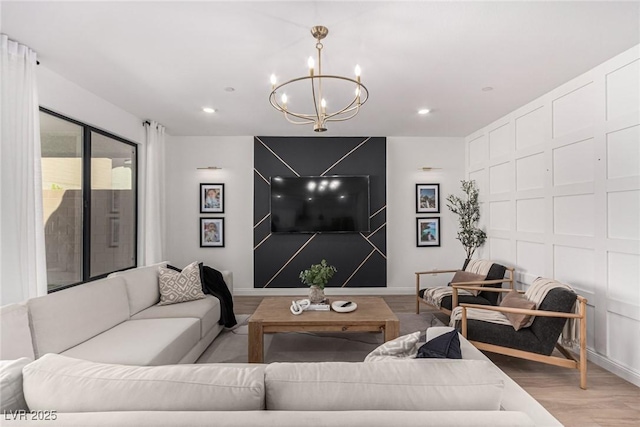 living room with a notable chandelier and wood-type flooring