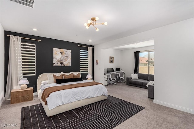 carpeted bedroom with an inviting chandelier