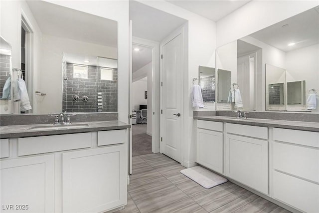 bathroom featuring vanity and a tile shower