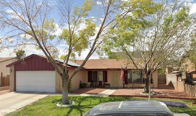 ranch-style home with a garage and a front yard