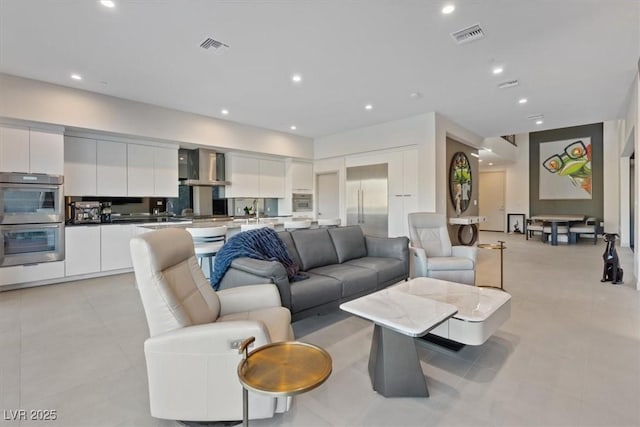 living room featuring light tile patterned floors, visible vents, and recessed lighting