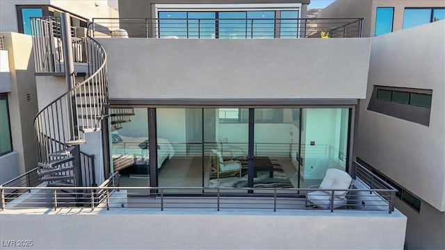 exterior space with stairs and stucco siding