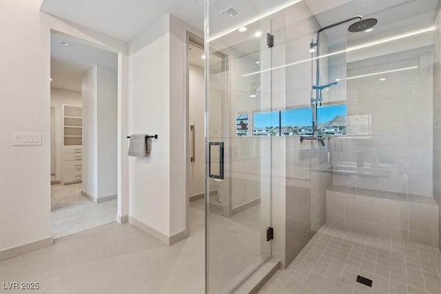 full bathroom with a stall shower, visible vents, and baseboards