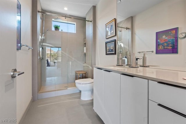 bathroom featuring toilet, a stall shower, tile patterned floors, and vanity