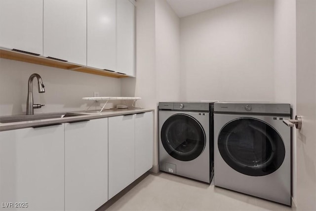 laundry area featuring a sink, cabinet space, and washer and dryer