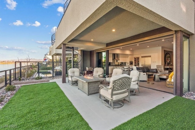 view of patio / terrace with a water view, stairs, and a fire pit