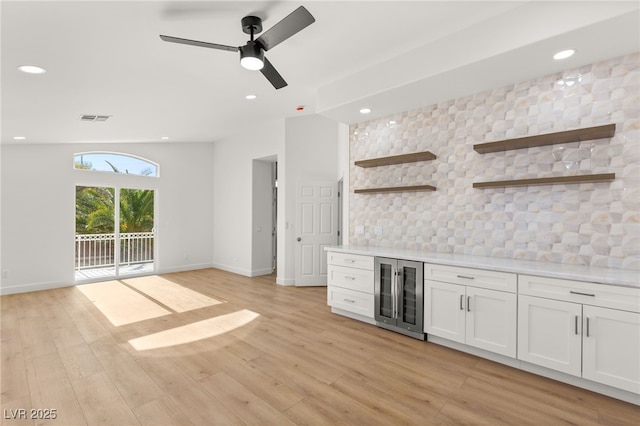 bar featuring wine cooler, white cabinetry, ceiling fan, and light hardwood / wood-style floors