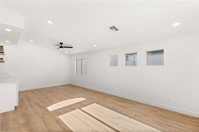 empty room featuring ceiling fan and light hardwood / wood-style flooring