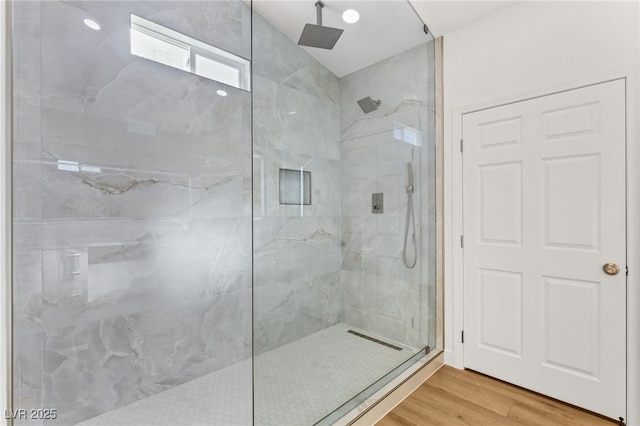 bathroom featuring tiled shower and hardwood / wood-style floors