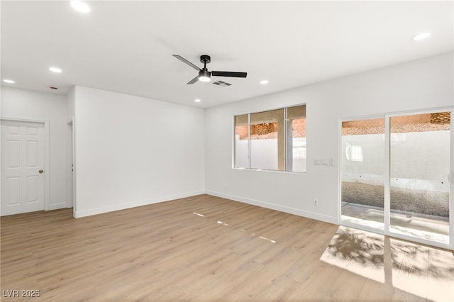 empty room featuring ceiling fan and light hardwood / wood-style flooring