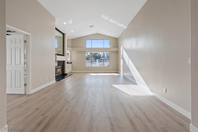 unfurnished living room with light hardwood / wood-style flooring and vaulted ceiling