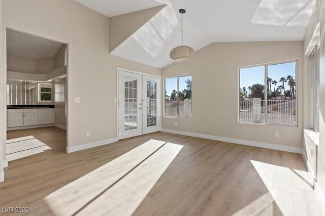 interior space with french doors, light wood-type flooring, and a healthy amount of sunlight