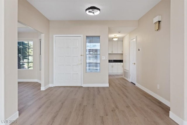 foyer entrance with light wood-type flooring