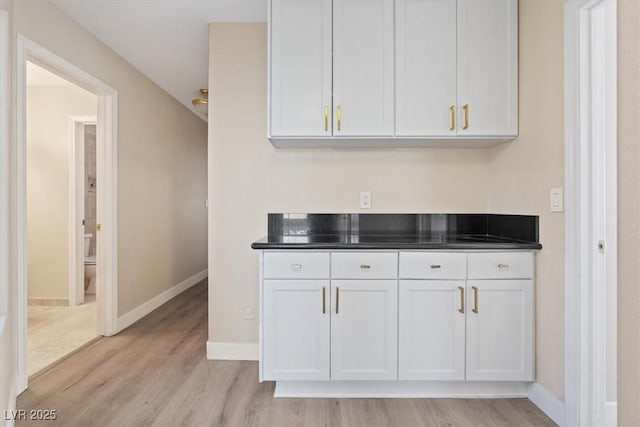 kitchen featuring light wood-type flooring and white cabinetry