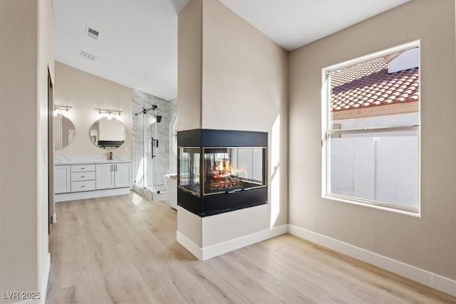 interior space with light hardwood / wood-style flooring and sink