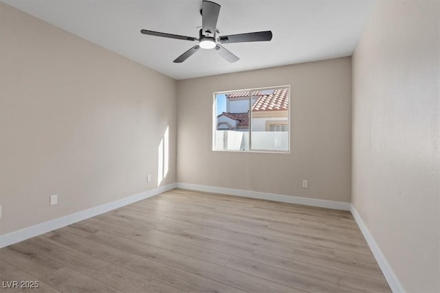 empty room with ceiling fan and light hardwood / wood-style floors