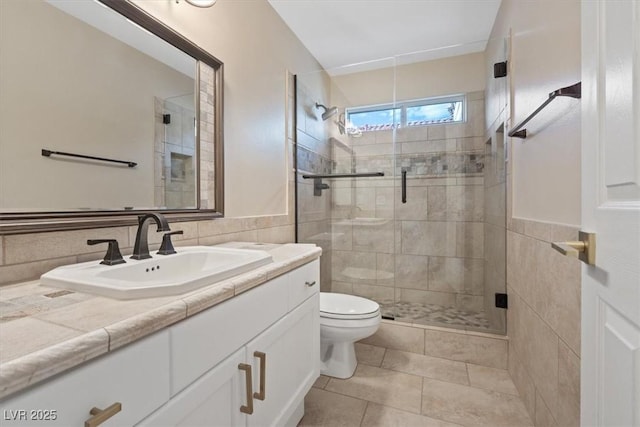 bathroom featuring vanity, tile patterned flooring, toilet, tile walls, and walk in shower