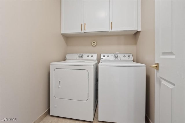 laundry area with cabinets and washing machine and clothes dryer