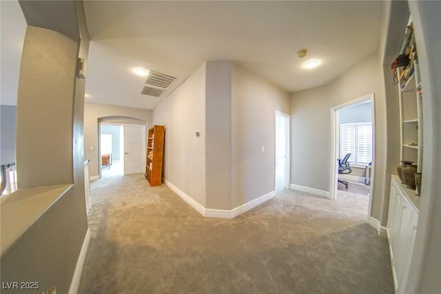 hallway with light colored carpet