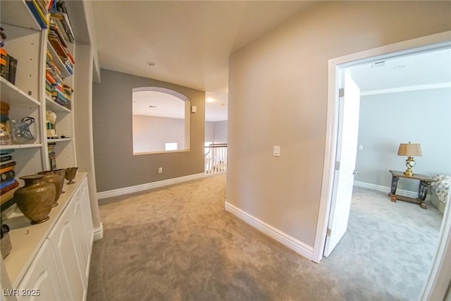 hallway featuring light carpet