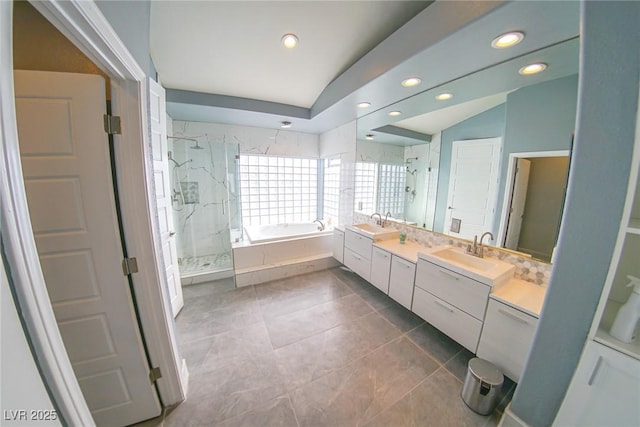 bathroom with vanity, shower with separate bathtub, tile patterned flooring, and vaulted ceiling