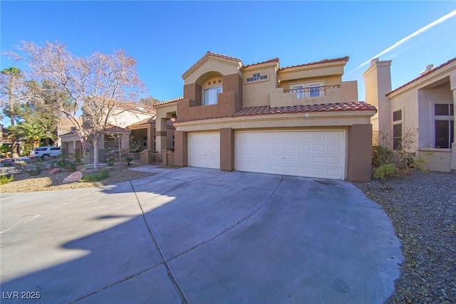 mediterranean / spanish-style home with a garage