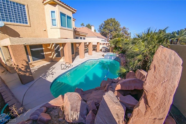 view of swimming pool with a patio